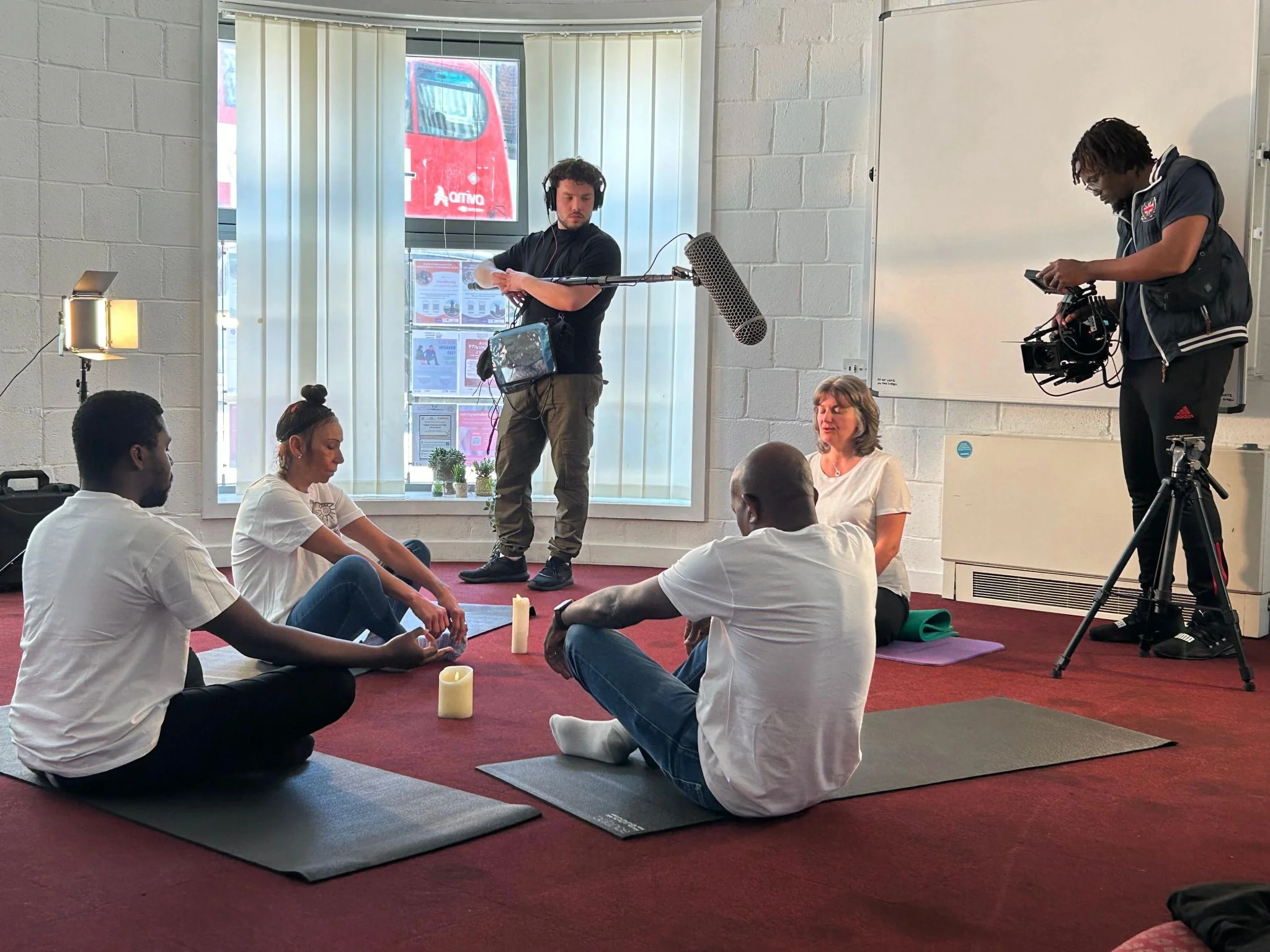 A production where people are meditating. A production where people are meditating.